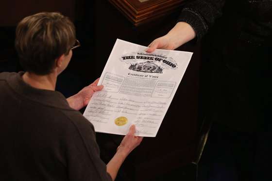 WASHINGTON, DC - JANUARY 04: Congressional clerks pass the Electoral College certificate from the state of Ohio while unsealing and organizing all the votes from the 50 states in the House of Representatives chamber at the U.S. Capitol January 4, 2013 in Washington, DC. The votes were tallied during a joint session of the 113th Congress. President Barack Obama and Biden received 332 votes to be reelected. (Photo by Chip Somodevilla/Getty Images)