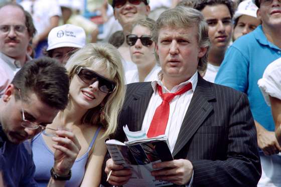 Developer Donald Trump (R) and his fiancee Marla Maples watch second round action at the US Open tennis tournament on August 28, 1991. AFP PHOTO TIMOTHY A. CLARY (Photo credit should read TIMOTHY A. CLARY/AFP/Getty Images)