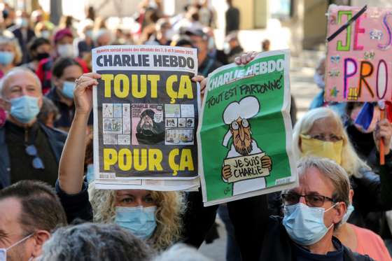 Protesters wearing face masks hold placards during the