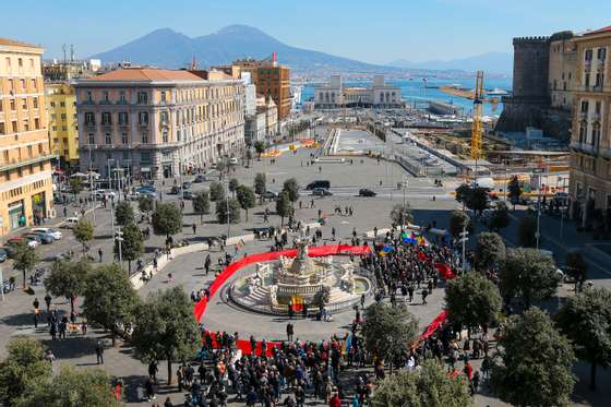 People with a giant red flag, in Municipio square,