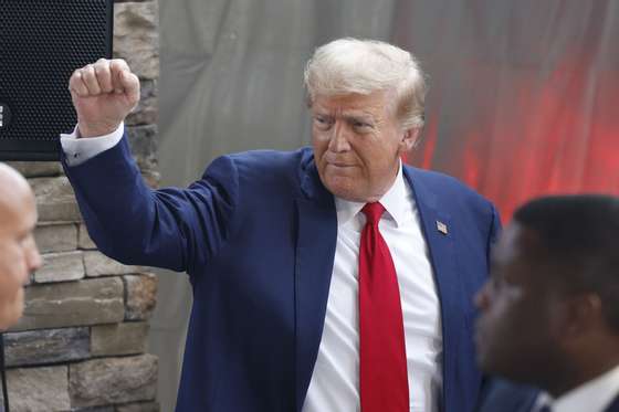 epa11642584 Former US president and Republican presidential nominee Donald Trump gestures after speaking to the news media with Georgia Governor Brian Kemp (not pictured) in the wake of damage and recovery from Hurricane Helene in Evans, Georgia, USA, 04 October 2024. The Augusta area suffered major damage after Helene swept through. Trump is running against Democratic US Vice President Kamala Harris.  EPA/ERIK S. LESSER