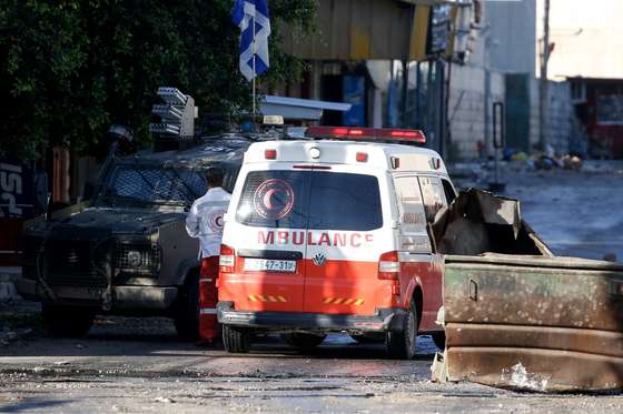 epa11028189 An ambulance trying to reach Jenin Hospital is stopped for search by the Israeli forces as their raid on Jenin refugee camp enters a third consecutive day, near the West Bank city of Jenin, 14 December 2023. According to the Palestinian Health Ministry, at least 11 Palestinians have been killed in Jenin since 12 December during Israeli military raids. Thousands of Israelis and Palestinians have died since the militant group Hamas launched an unprecedented attack on Israel from the Gaza Strip on 07 October, and the Israeli operations in Gaza and the West Bank which followed it.  EPA/ALAA BADARNEH