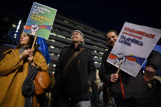 Protesters hold banners with the words "Latin America is not the US back yard (L)" and "Solidarity with the peoples of Latin America" during the "End US military aggression against Venezuela" protest organised by the Portuguese Council for Peace and Cooperation (CPPC) in Porto, Portugal, 5th January 2026. RICARDO CASTELO/LUSA
