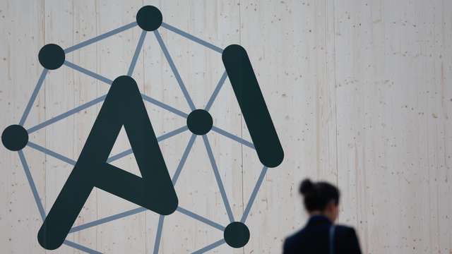 epa11886490 A person walks past the logo of the Artificial Intelligence (AI) Action Summit at the Grand Palais in Paris, France, 10 February 2025. The summit takes place from 10 to 11 February.  EPA/MOHAMMED BADRA