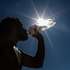 epa10870534 A man drinks water during a break from physical activity on Copacabana Beach in Rio de Janeiro, Brazil, 19 September 2023. Brazil is facing a heat wave in nine states of the country that will last between three and five days and will lead temperatures to be five degrees higher than the historical average, the National Institute of Meteorology warned.  EPA/ANDRE COELHO