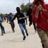 epaselect epa13309134 Palestinians run for cover from tear gas fired by the Israeli army following a settlers' attack on families harvesting their olive trees in Abu Falah, West Bank, 16 October 2026. According to Wafa, several Palestinians and a foreign journalist were injured in Israeli settler attacks on residents and olive pickers up to 3 locations in the central West Bank.  EPA/ATEF SAFADI