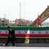 epa13129785 A person with a musical instrument walks next to Iranian missiles, Zolfaghar, on display at Azadi Square in Tehran, Iran, 24 July 2026. Conflict between Iran and the US over the Strait of Hormuz continues, as US strikes have targeted several locations across Iran.  EPA/ABEDIN TAHERKENAREH RESTRICTIONS: NO Access Israel Media/Persian Language TV Stations Outside Iran/Strictly No Access BBC Persian/VOA Persian/Manoto TV/Iran International TV. (As mandated by Iran's Directorate General for Foreign Media) --