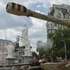 epa13063725 A worker cleans the monument to Princess Olga next to an exhibition of destroyed Russian military machinery on Mykhailivska Square in Kyiv, Ukraine, 25 June 2026, amid the ongoing Russian invasion. Specialists of the Ukrainian multi-service company 'INVITE' are opening and cleaning significant monuments in Kyiv after their protective conservation, which was carried out at the start of the Russian invasion in 2022.  EPA/SERGEY DOLZHENKO