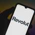 In this photo illustration a Revolut logo seen displayed on