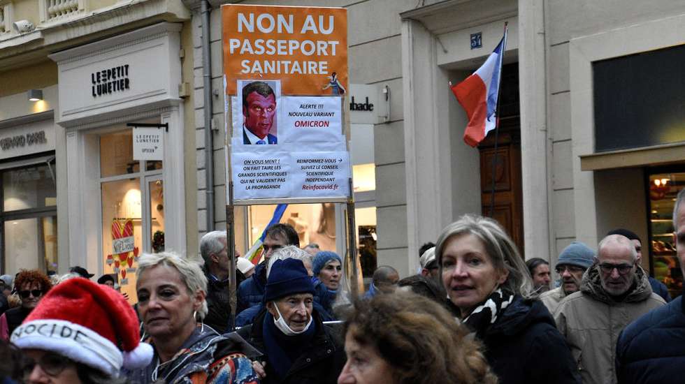 A protester holds a placard while marching through the