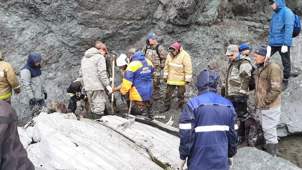 epa09327873 A handout photo made available 07 July 2021 by the press service of the Russian Ministry for Civil Defence, Emergencies and Elimination of Consequences of Natural Disasters (EMERCOM of Russia) shows rescue workers at the wreckage of the An-26 plane outside the town of Palana, Kamchatka, Russia. An An-26 plane with 28 people on board en route from Petropavlovsk-Kamchatsky to Palana was lost about 10 minutes before landing.  EPA/EMERCOM OF RUSSIA PRESS SERVICE HANDOUT MANDATORY CREDIT/BEST QUALITY AVAILABLE/ HANDOUT EDITORIAL USE ONLY/NO SALES