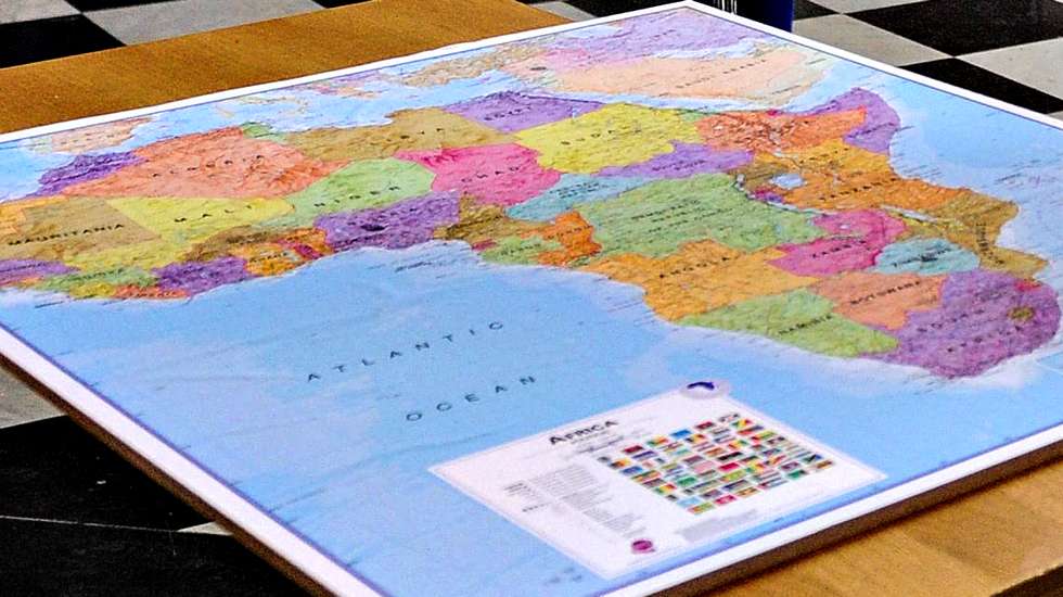 epa03627394 The Archbishop of Canterbury, the Most Rev Justin Welby (C) prays in front of a map of Africa in St. Paul's cathedral as he conducts a 'journey in prayer' from the City of London to Southwark Cathedral, London, Britain, 16 March 2013.  EPA/FACUNDO ARRIZABALAGA