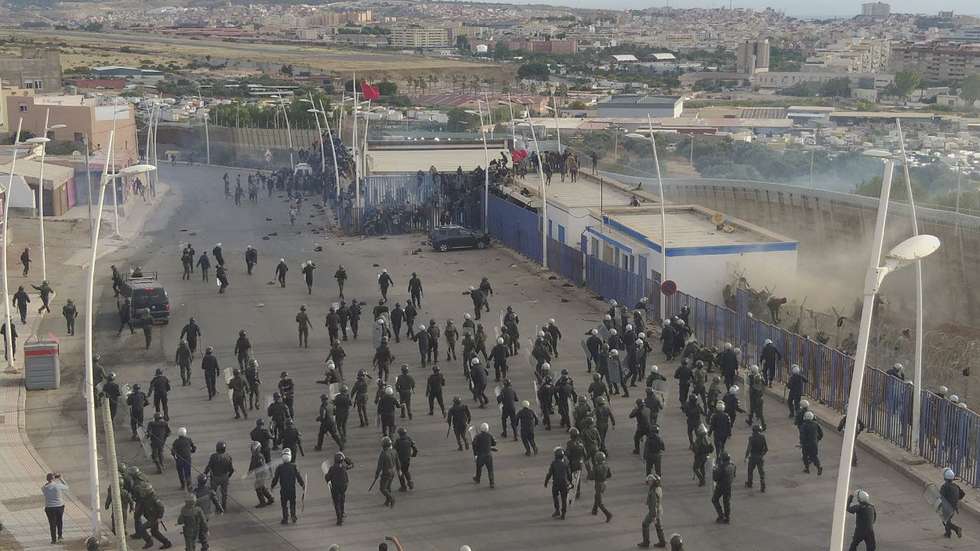 epa10033626 A handout photo made available by a local resident shows hundred of migrants crossing the Spanish and Morocco Melilla border near Nador, Morocco, 24 June 2022 (issued 25 June 2022). At least 18 African migrants have died when around 2,000 mostly sub-Saharan African migrants tried to force the Spanish-Moroccan border on 24 June. About 500 migrants managed to reach the border fence and broke the border gate with a wire cutter. Spanish Prime Minister Pedro Sanchez described the attempt as an attack on Spain's 'territorial integrity'.  EPA/STRINGER / HANDOUT  HANDOUT EDITORIAL USE ONLY/NO SALES