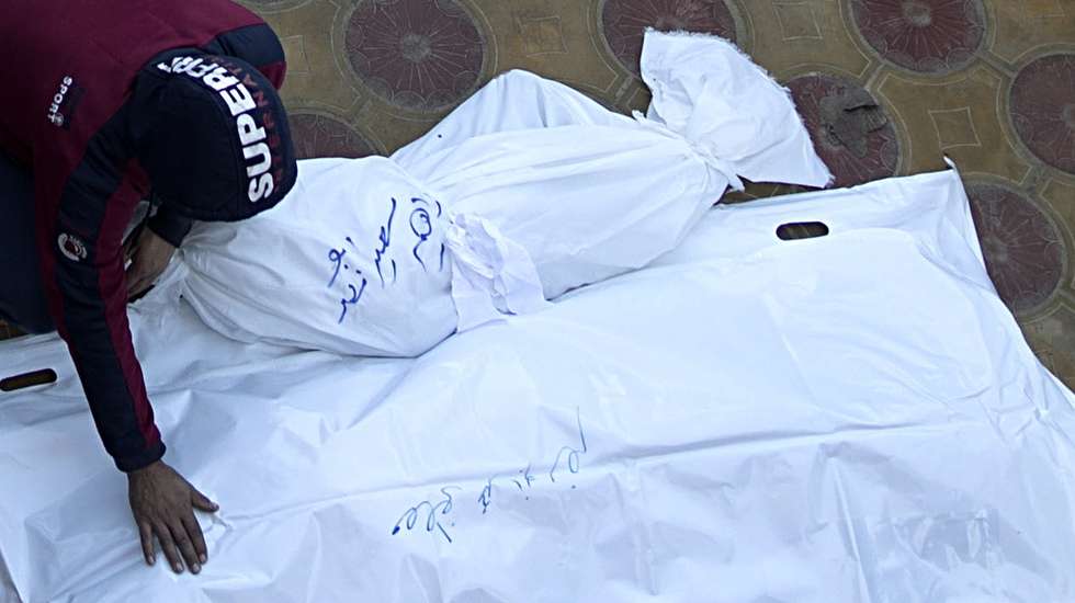 epa11030611 A relatives of Palestinians from the AL-Gandor family who died following Israeli airstrikes in the southern Gaza Strip, mourns next to their wrapped bodies, outside the Nasser Hospital in Khan Yunis, southern Gaza Strip, December 15, 2023.. Israeli forces resumed military strikes on Gaza after the week-long truce ended on December 1. At least 18,000 Palestinians and at least 1,200 Israelis have been killed, according to the Palestinian Health Ministry and the Israel Defense Forces (IDF), since Hamas militants launched an attack against Israel from the Gaza Strip on 07 October, and the Israeli operations in Gaza and the West Bank which followed it.  EPA/HAITHAM IMAD