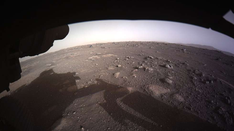 epa09024690 A handout photo made available by NASA shows the first high-resolution, color image to be sent back by the Hazard Cameras (Hazcams) on the underside of NASA's Perseverance Mars rover after its landing, on 18 February 2021 (issued 19 February 2021). A camera aboard the descent stage captured this shot. A key objective for Perseverance's mission on Mars is astrobiology, including the search for signs of ancient microbial life. The rover will characterize the planet's geology and past climate, pave the way for human exploration of the Red Planet, and be the first mission to collect and cache Martian rock and regolith.  EPA/NASA/JPL-Caltech HANDOUT  HANDOUT EDITORIAL USE ONLY/NO SALES