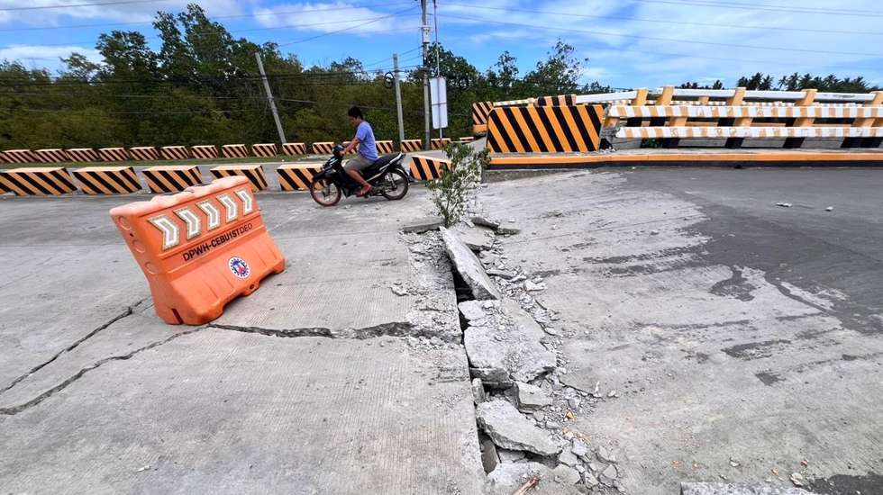 epa12419026 A rider crosses a damaged bridge in the aftermath of an earthquake, in Medellin, Cebu island, Philippines, 01 October 2025. A magnitude 6.9 earthquake struck off the coast of Cebu island late on 30 September, with the epicenter in Bogo City, killing more than 60 people, according to Cebu Provincial Disaster Risk Reduction and Management Office (PDRRMO).  EPA/JUANITO ESPINOSA