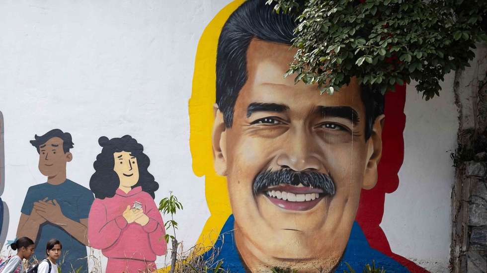 epa12701089 People walk past a mural of Venezuelan President Nicolas Maduro in Caracas, Venezuela, 02 February 2026. Chavismo marks 27 years in power in Venezuela, with its current leader, Nicolas Maduro, detained in the United States after US forces captured him nearly a month ago along with his wife, Congresswoman Cilia Flores, amid a series of US military attacks on Venezuelan soil.  EPA/RONALD PENA R