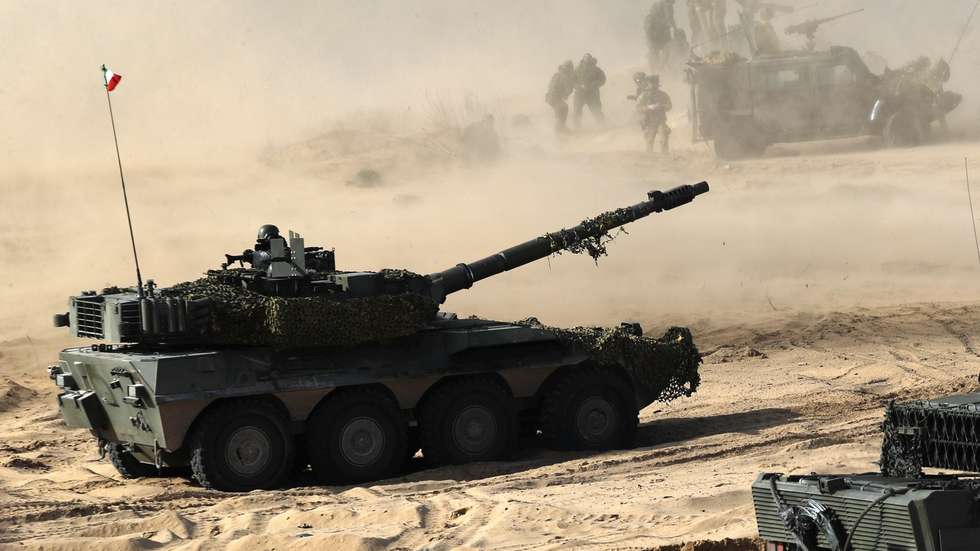 epa09817834 Spanish Army serviceman with their battle tank Leopard (R) during the international military exercise Crystal Arrow 22, organized by Mechanized Infantry Brigade of the Latvian Land Forces in Adazi training ground, Latvia, 11 March 2022. The purpose of the force demonstration is to demonstrate the interoperability of multinational units in various operations and to demonstrate NATO's combat capabilities for the protection of any member of the Alliance. With the conclusion of the Crystal Arrow 2022 exercise, the certification process of the NATO Extended Presence Battlegroup in Latvia is being successfully completed.  EPA/TOMS KALNINS