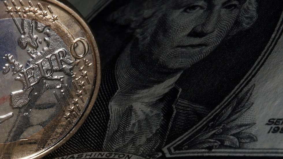 epa04393774 An illustration picture shows a euro coin next to a US dollar bill in Cologne, Germany, 10 September 2014. The euro on 09 September fell to a new 14 month low, costing 1.2860 US dollars. EPA/OLIVER BERG