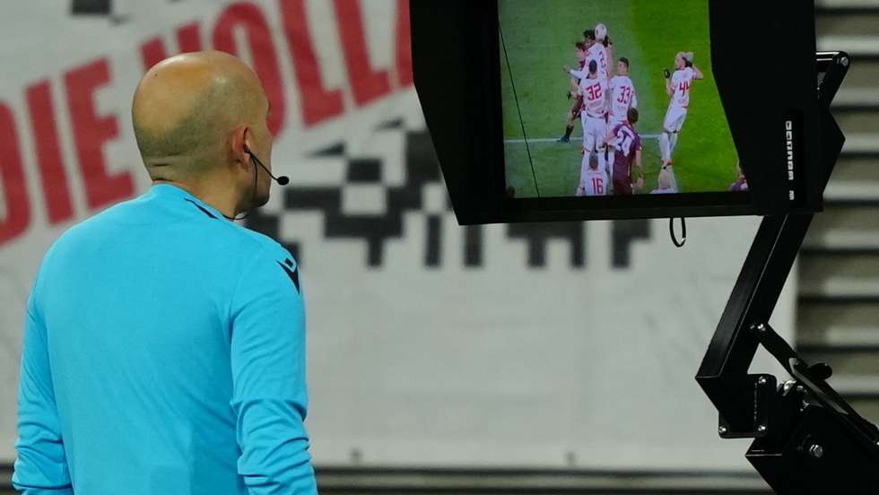 epa09767602 Referee Cuneyt Cakir uses the VAR system during the UEFA Europa League play-off soccer match between RB Leipzig and Real Sociedad in Leipzig, Germany, 17 February 2022.  EPA/CLEMENS BILAN