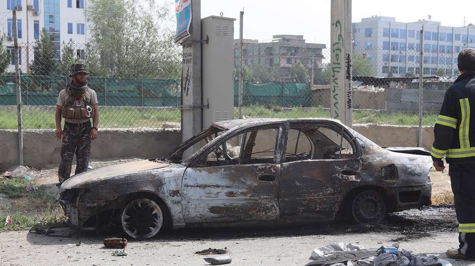 epa09354536 Afghan security officials inspect a vehicle that was damaged after rockets were fired at the Presidential Place during Eid al-Adha prayers in Kabul, Afghanistan, 20 July 2021. The Afghan government and the Taliban have agreed to hold fresh discussions after peace talks in Doha ended over the weekend without an agreement over the situation in Afghanistan, which has witnessed unprecedented violence since the foreign troops began pulling out in May. Since May, the Taliban have captured more than 130 district centers across Afghanistan, especially in the northern parts of the country.  EPA/JAVED KARGAR