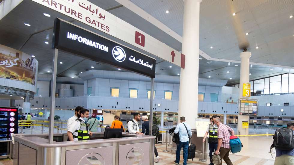 epa09542802 Passengers walk at departure gate at Kuwait international airport in Kuwait City, Kuwait, 24 October 2021. Kuwait resumed full operations of Kuwait International Airport as of 24 October as the country is further easing covid-19 restrictions.  EPA/NOUFAL IBRAHIM