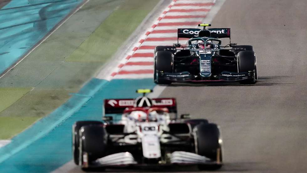 epa09638262 Italian Formula One driver Antonio Giovinazzi (front) of Alfa Romeo Racing ORLEN and German Formula One driver Sebastian Vettel (back) of Aston Martin Cognizant F1 Team in action during the 2021 Formula One Grand Prix of Abu Dhabi at Yas Marina Circuit in Abu Dhabi, United Arab Emirates, 12 December 2021.  EPA/Ali Haider