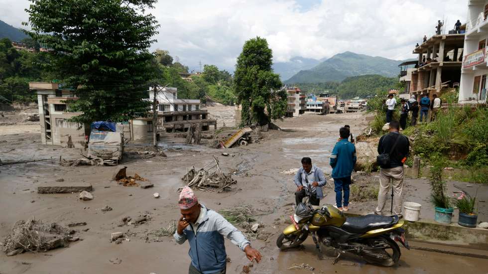 epa13191982 Villagers wade through flooded streets following a flash flood in Trishuli Bazar, Nuwakot district, Nepal, 26 August 2026. Several people were killed and multiple others were reported missing after a massive flash flood swept through Rasuwa and Nuwakot districts causing widespread destruction to settlements and infrastructure, according to local authorities.  EPA/NARENDRA SHRESTHA