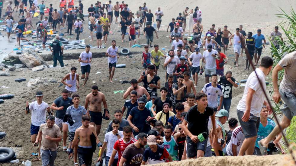epa13141875 Migrants reach Spanish territory after swimming from Morocco to Ceuta, a Spanish enclave in North Africa, 30 July 2026. Hundreds of migrants swam to cross the border to Ceuta over the last nine days, mainly Moroccan and Algerian. Ceuta officials asked the Spanish government to declare a 'national emergency.'  EPA/Reduan Dris BEST QUALITY AVAILABLE