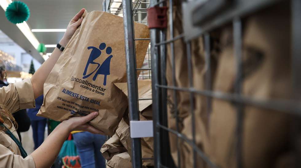 Voluntários trabalham na recolha de alimentos num supermercado, em Lisboa, 27 de novembro de 2021. Nos próximos dias 27 e 28 de novembro, a campanha de recolha de alimentos promovida pelos Bancos Alimentares Contra a Fome volta a ter equipas de voluntários nos supermercados de todo o país, a convidar os portugueses, de forma mais pessoal, à partilha de alimentos com as famílias com necessidades para que possam ter, não só um Natal mais feliz, mas alimento à mesa todos os dias.  RODRIGO ANTUNES/LUSA