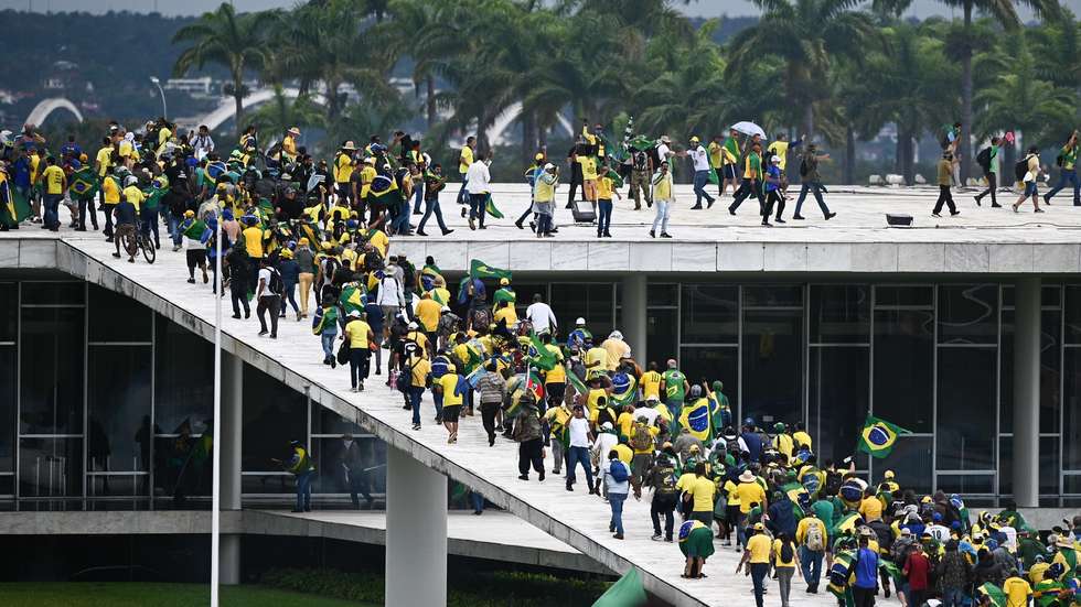 epa10396233 Bolsonaro supporters storm the National Congress in Brasilia, Brazil, 08 January 2023. Hundreds of supporters of former Brazilian President Jair Bolsonaro invaded the headquarters of the National Congress, and also Supreme Court and the Planalto Palace, seat of the Presidency of the Republic, in a demonstration calling for a military intervention to overthrow President Luiz Inacio Lula da Silva. The crowd broke through the cordons of security forces and forced their way to the roof of the buildings of the Chamber of Deputies and the Senate, and some entered inside the legislative headquarters.  EPA/ANDRE BORGES