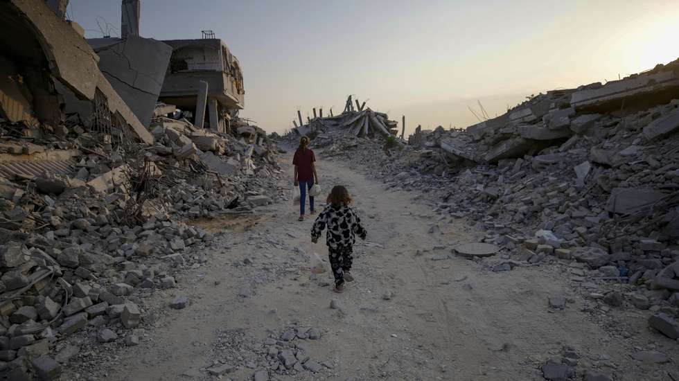 epa12503260 Palestinian children walk between the rubble of destroyed buildings in Jabaliya northern Gaza Strip, 04 Nove,ber 2025, amid a ceasefire between Israel and Hamas. Following Israeli claims that Hamas violated the ceasefire, Prime Minister Netanyahu ordered military strikes on the Gaza Strip on 28 October. In response, Hamas announced it was postponing the planned handover of a recovered hostage's body, citing Israeli truce violations.  EPA/MOHAMMED SABER