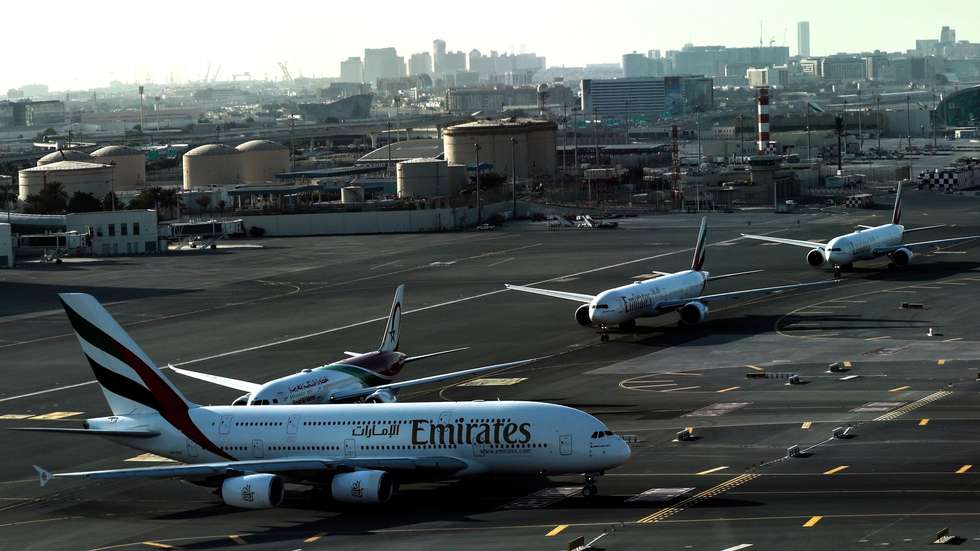 epa11850499 An aerial view taken from behind airplane's window glass shows a queue of commercial airplanes wait at the runway of Dubai International Airport for taking off in Dubai, United Arab Emirates, 24 January 2025.  EPA/ALI HAIDER