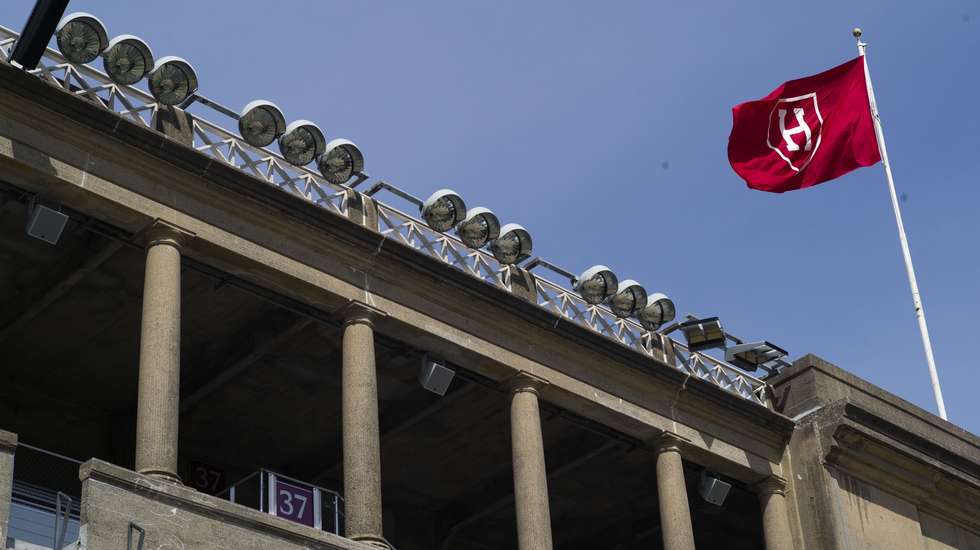 epa12006303 The Harvard flag flies over Harvard Stadium on the campus of Harvard University in Allston, Massachusetts, USA, 02 April 2025. The Department of Education announced on 30 March 2025 that there would be a comprehensive review of contracts and grants at Harvard University and its affiliates, as part of the Joint Task Force to Combat Anti-Semitism.  EPA/CJ GUNTHER