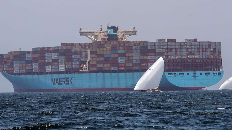 epa09995375 Dhows compete near Maersk vessel containers at the Al Gaffal Dhow Race outside Dubai, United Arab Emirates, 04 June 2022. Al Gaffal long distance Sur Bin Na'air 60ft Traditional Dhow Race (Dhow is a traditional boat) in Dubai is the biggest traditional sailing race in the world. 118 boats take part in the race which starts from Sur Bu Na'air Island reach the finish line at the coast of Dubai passing by Moon Island.  EPA/ALI HAIDER