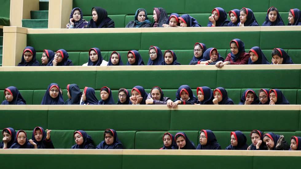 epa07248073 School girls listen to Iranian President Hassan Rouhani delivering his speech presenting the Iranian New Year budget during the parliament session in Tehran, Iran, 25 December 2018. According to reports, Rouhani said in his speech that US, by forcing sanctions against the country, hits the lives, development and economic growth. Rouhani presented the budget draft at about 4,700 trillion Iranian Rials for the next Iranian year which starts on 21 March 2019.  EPA/ABEDIN TAHERKENAREH