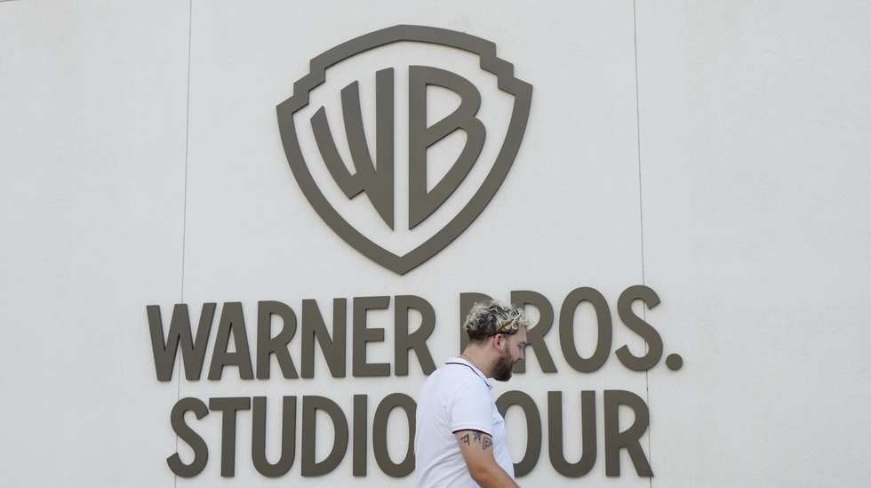 epa12471315 A person walks by the Warners Bros. studio tour location at the Warner Bros. Studio Lot in Burbank, California, USA, 21 October 2025. Warner Bros. Discovery revealed in a press release on 21 October that it is putting the company up for sale.  EPA/CAROLINE BREHMAN