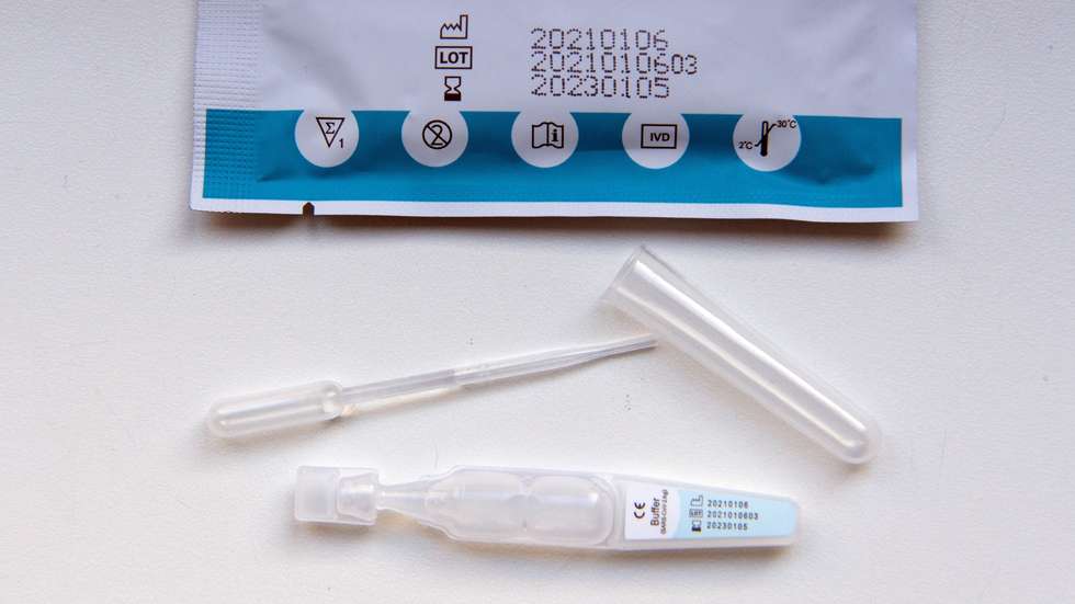 epa09013826 The content of the covid-19 rapid test kit is displayed during the visit of German Families Minister Franziska Giffey, in the 'Abenteuerland' day care center in Potsdam, Germany, 15 February 2021. The so-called spit tests have been used by daycare educators since the beginning of the month to test themselves at home twice a week before work.  EPA/SOEREN STACHE / POOL