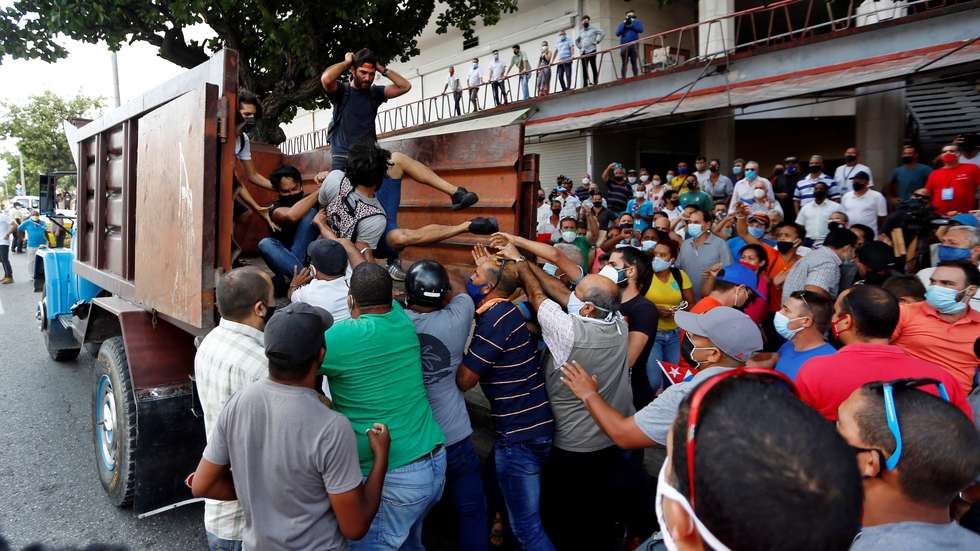 epa09339353 People force anti-government protestors into a truck during a pro-government rally in Havana, Cuba, 11 July 2021. Cuban President Miguel Diaz-Canel encouraged his supporters to take the streets as a response to protest against his governement. Thousands of Cuban took the streets on 11 July to protest against Cuba's government, in what is considered the first major protest in the last 60 years.  EPA/Ernesto Mastrascusa