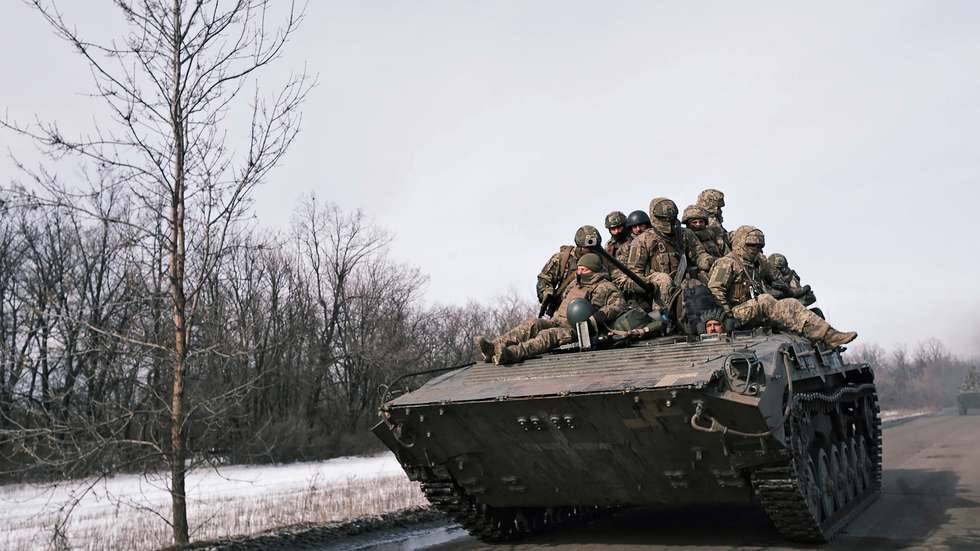 epa10489115 Ukrainian servicemen ride atop an APC on a road in Bakhmut, Ukraine, 24 February 2023. Russian troops entered Ukrainian territory on 24 February 2022, starting a conflict that has provoked destruction and a humanitarian crisis. One year on, fighting continues in many parts of the country.  EPA/GEORGE IVANCHENKO