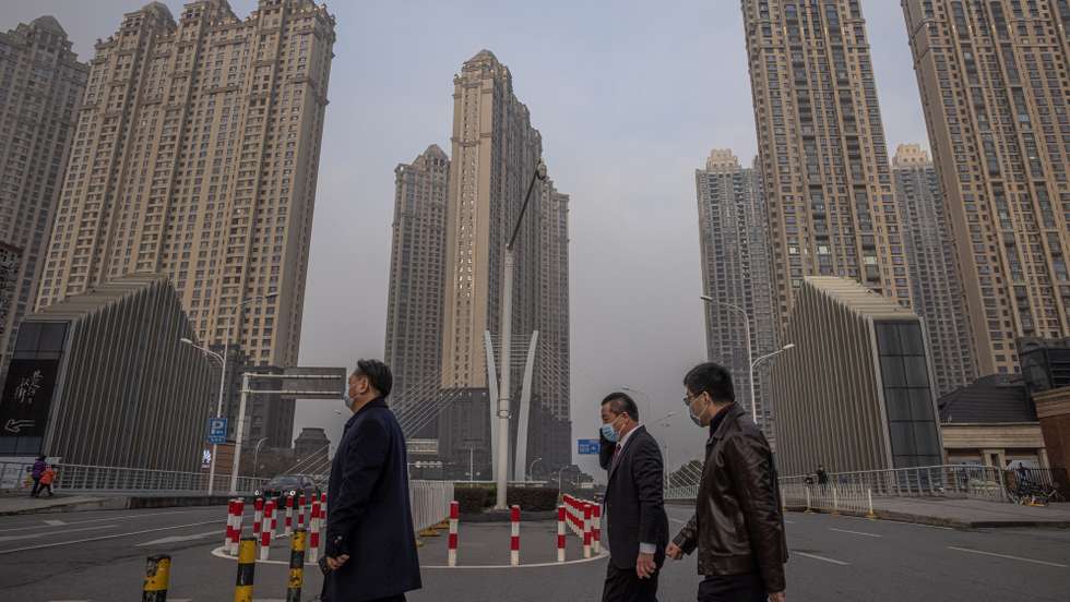 epa08959714 People wearing protective face masks cross a road, on the day of Wuhan's lockdown one-year anniversary, in Wuhan, China, 23 January 2021. The day 23 January 2021 marks the one-year anniversary of the start of a strict 76-day lockdown of the Chinese city of Wuhan, where the novel coronavirus SARS-CoV-2 that causes the COVID-19 disease, was first discovered before spreading across the world into a deadly global pandemic.  EPA/ROMAN PILIPEY