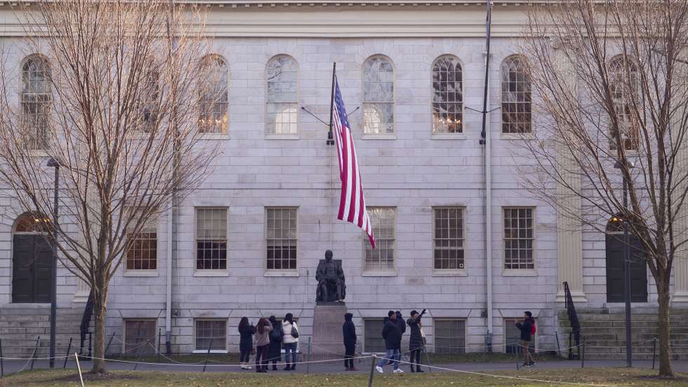 epa11055501 Tourists take photographs near the statue of John Harvard in Harvard Yard on the campus of Harvard University in Cambridge, Massachusetts, USA, 03 January 2024. Harvard University President Claudine Gay resigned as the shortest tenure of the position, in wake of plagiarism allegations and a recent congressional hearing regarding the response by the school to the Israel-Hamas war.  EPA/CJ GUNTHER