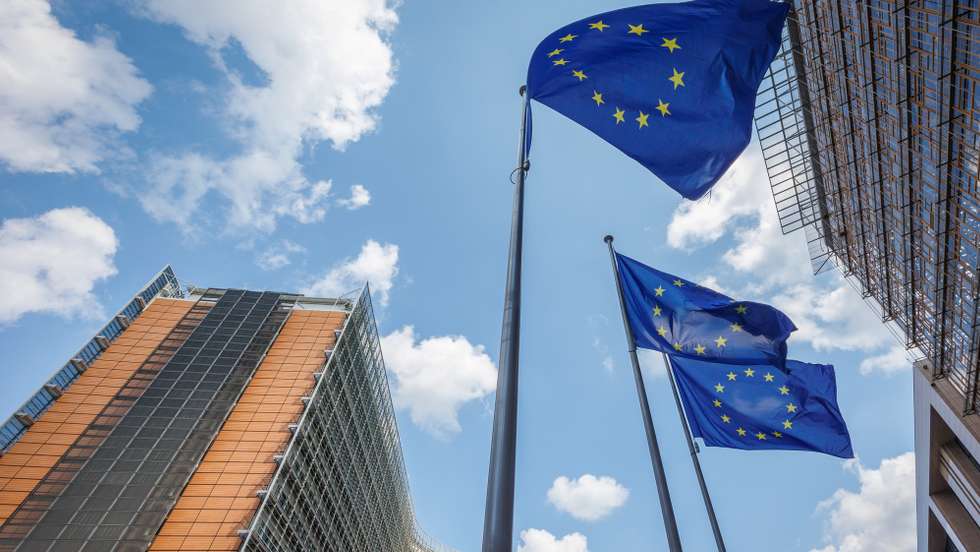 epa11483897 European Union flags flutter in front of the European Commission Berlaymont building (L), in Brussels, Belgium, 17 July 2024. The European Parliament is scheduled to vote on 18 July on Ursula von der Leyen's second term as EU Commission President.  EPA/OLIVIER MATTHYS
