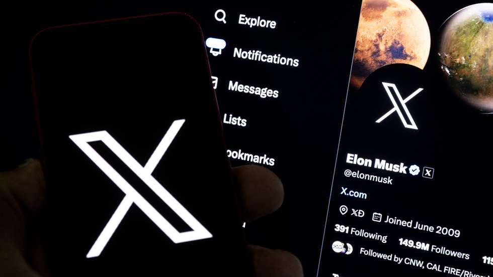 epa10772473 An illustration pictures shows a user holding a mobile phone displaying the 'X' logo in front of Elon Musk's page in Los Angeles, California, USA, 27 July 2023. Twitter announced on 23 July that it will rebrand to X.  EPA/ETIENNE LAURENT