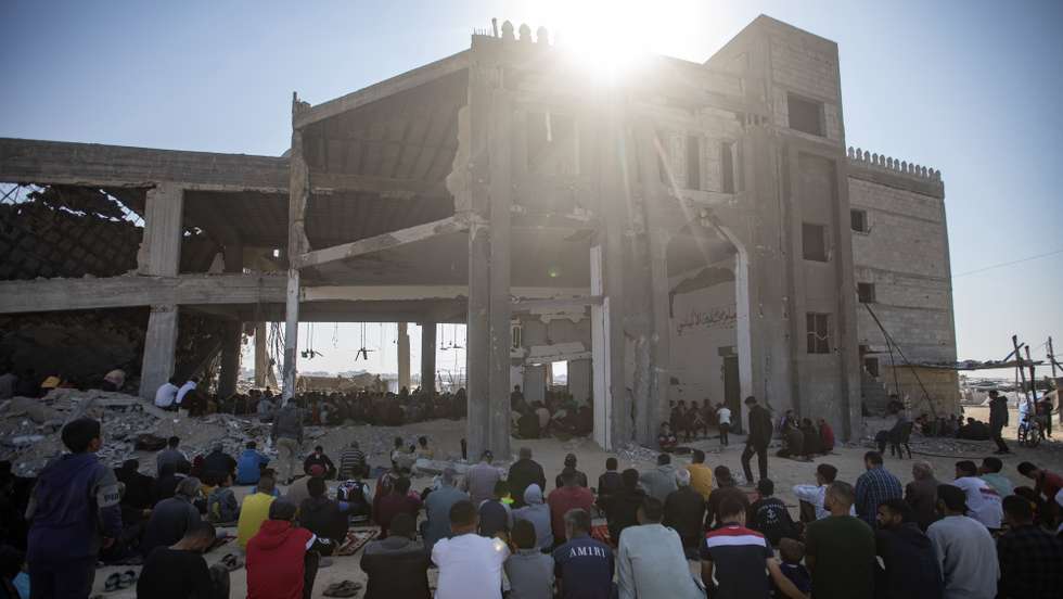 epa11734546 Palestinians perform Friday prayers on the ruins of the Albani Mosque, which was destroyed in an Israeli military strike, in Khan Yunis, southern Gaza Strip, 22 November 2024. More than 44,000 Palestinians and over 1,400 Israelis have been killed, according to the Palestinian Health Ministry and the Israeli Army, since Hamas militants launched an attack against Israel from the Gaza Strip on 07 October 2023, and the Israeli operations in Gaza and the West Bank which followed it.  EPA/HAITHAM IMAD