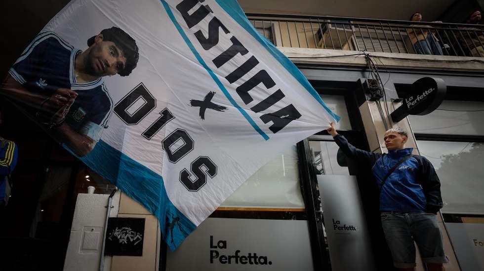 epa11956056 Diego Armando Maradona's supporters wait in front of the San Isidro courthouse in Buenos Aires, Argentina, 11 March 2025. Diego Armando Maradona's daughters, Dalma, Giannina, and Jana, arrived at the Criminal Court Number 3 of San Isidro, province of Buenos Aires, to attend the first hearing of the trial for the death of their father.  EPA/JUAN IGNACIO RONCORONI