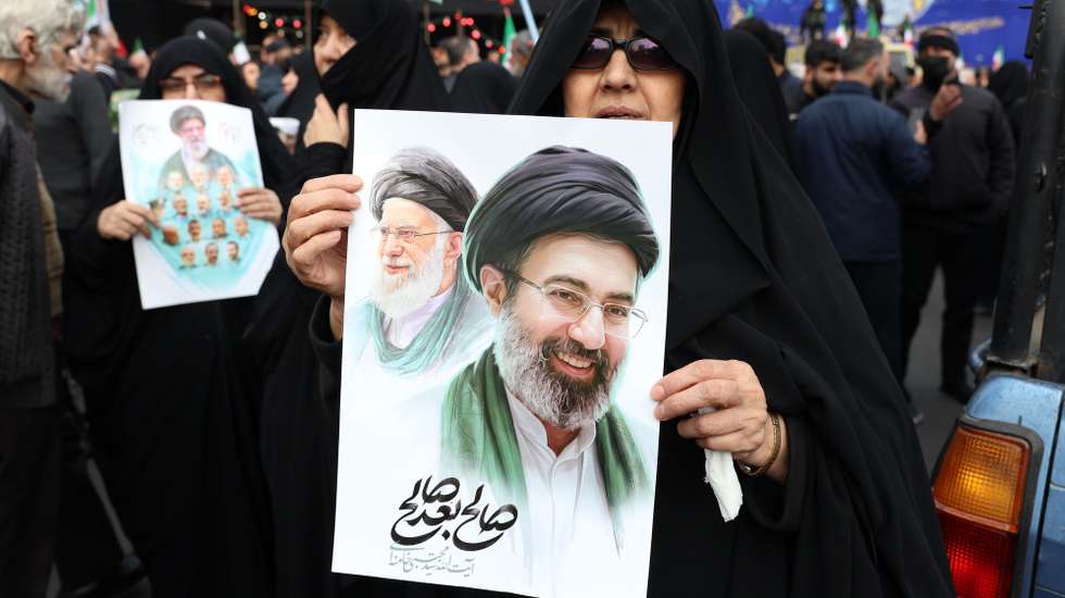 epa12811438 Iranians hold posters of the new Iranian supreme leader Ayatollah Mojtaba Khamenei during a mass funeral for the Iran's Revolutionary Guards Corps (IRGC) commanders, army commanders and other victims who were killed during the Iran-US and Israel war in Tehran, Iran, 11 March 2026. A joint Israeli and US military operation continues to target multiple locations across Iran since the early hours of 28 February 2026.  EPA/ABEDIN TAHERKENAREH