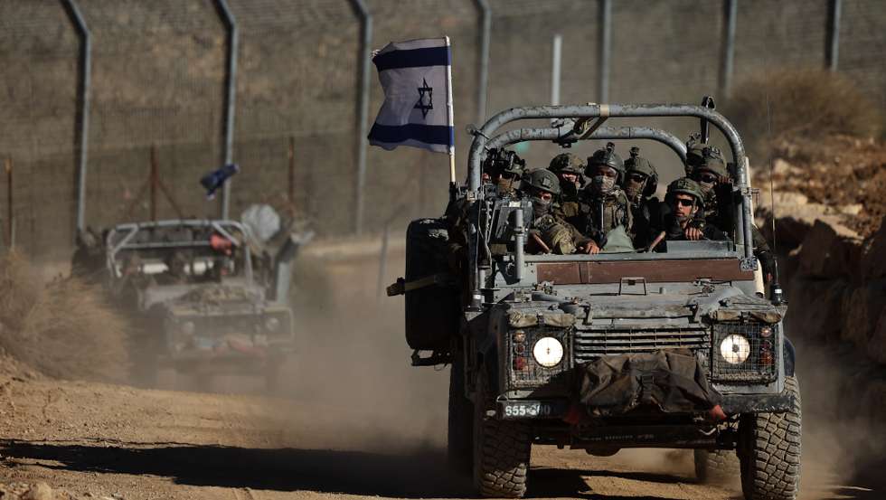 epa11783655 An Israeli flag is displayed on an army vehicle as troops leave the buffer zone on the border between Israel and Syria, near the Druze village of Majdal Shams, in the Israeli-annexed Golan Heights, 18 December 2024. Israel's military said that paratroopers' forces, joined by other troops, are conducting 'defence activities' to prevent 'any threat' and are deployed in key positions within the buffer zone.  EPA/ATEF SAFADI