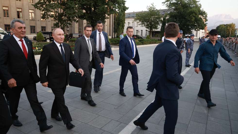 epa11556970 Russian President Vladimir Putin (2-L), accompanied by Head of the Republic of North Ossetia-Alania Sergei Menyailo (L), meets with people on the streets, in Vladikavkaz, Republic of North Ossetia-Alania, Russia, 20 August 2024.  EPA/VYACHESLAV PROKOFYEV/SPUTNIK/KREMLIN POOL MANDATORY CREDIT