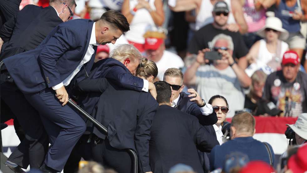 epaselect epa11476790 Former US President Donald Trump is rushed from stage by secret service after being shot at during a campaign rally at the Butler Farm Show Inc. in Butler, Pennsylvania, USA, 13 July 2024. Trump was rushed off stage by secret service after a shooting during a campaign rally in Pennsylvania. Former US President Donald Trump stated on social media that a bullet pierced the upper part of his right ear and that a person attending the rally was killed, another was injured and that the alleged shooter was dead. EPA/DAVID MAXWELL